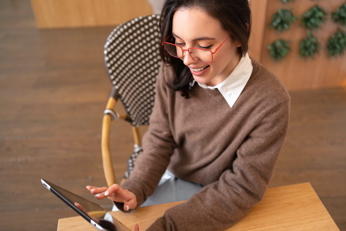 Woman in glasses use tablet computer