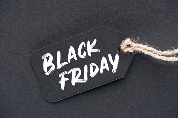 close up of sale tag with black friday sign on black