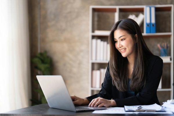 Business woman using calculator for do math finance on wooden desk in office and business working